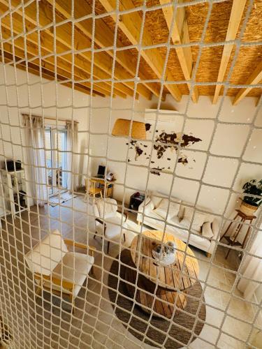 a room with a net in the middle of a room at Le Gite de l Ancre in Ville-sur-Ancre