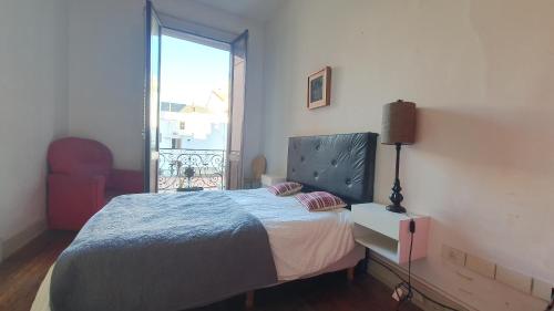 a bedroom with a bed and a large window at Hostal 2 in Buenos Aires