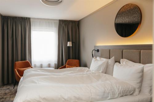 a hotel room with a large white bed and a window at Best Western Plus Kalmarsund Hotell in Kalmar