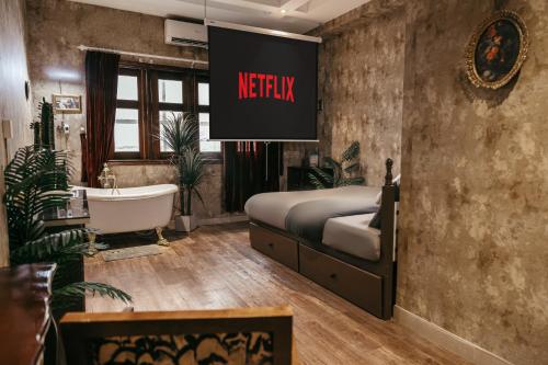a bedroom with a bed and a bath tub and a sign at Mustang 11-11 Boutique Hotel Self Check In in Ho Chi Minh City