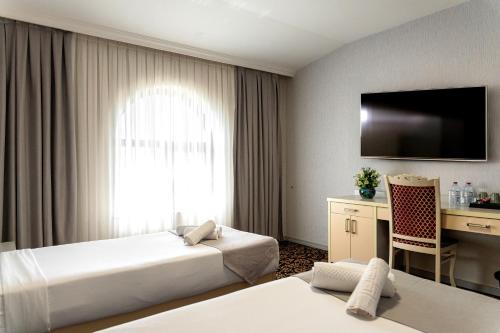 Postel nebo postele na pokoji v ubytování Alis Business Hotel baku
