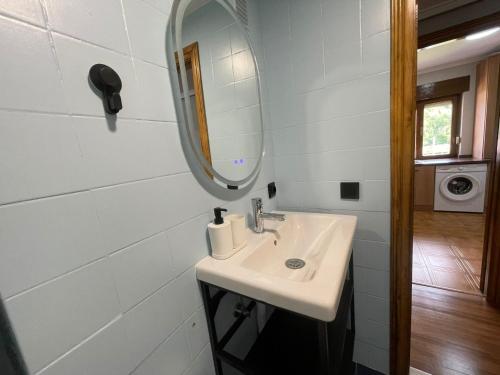 a bathroom with a sink and a mirror at Dacarreda in Villamayor