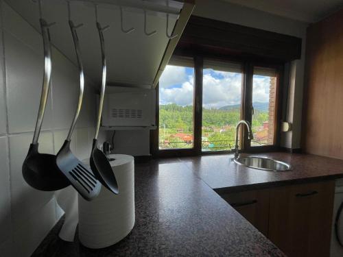 a kitchen with utensils hanging on the wall at Dacarreda in Villamayor