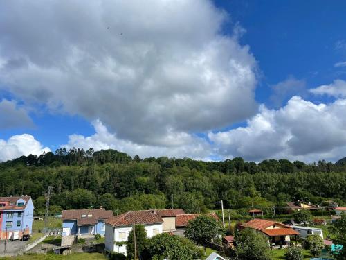 a small town with houses and trees on a hill at Dacarreda in Villamayor