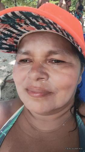 a young girl wearing a hat smiles at the camera at Camping e pousada dos sonhos in Carvalhos