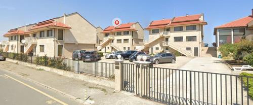 a row of houses with cars parked in a parking lot at Solar Rise apartment in Pomorie