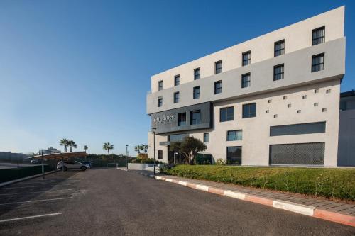 an empty parking lot in front of a building at Citadines Almaz Aparthotel Casablanca in Casablanca