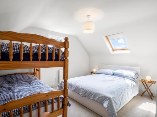 a bedroom with a bed and a bunk bed at Roundstone Vista in Roundstone