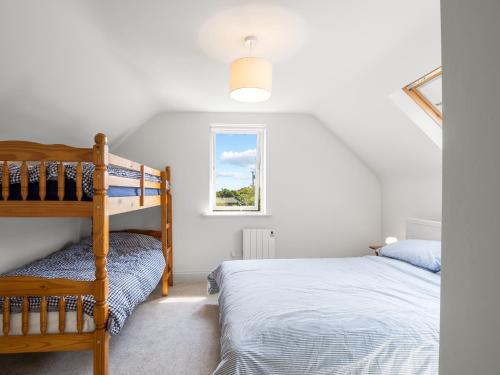 a bedroom with a bunk bed and a window at Roundstone Vista in Roundstone