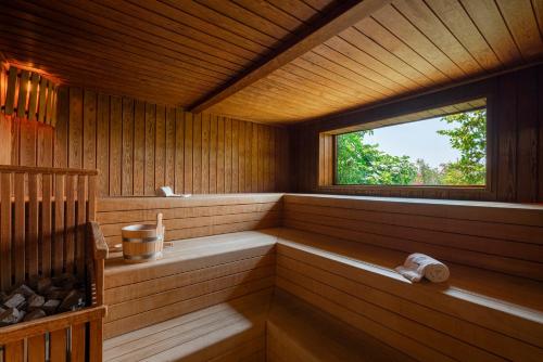 a sauna with a window in a wooden cabin at Il Boscareto Resort & Spa in Serralunga d'Alba