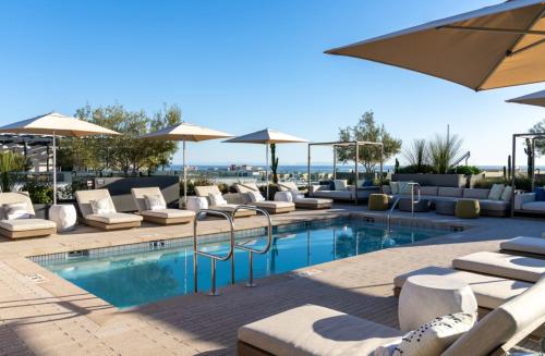 a swimming pool with lounge chairs and umbrellas at The Diamond Dune Three floors Two Balconies BBQ in Los Angeles