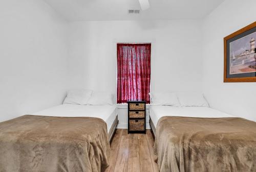 two beds sitting next to each other in a room at Myrtlewood by Monarch Rentals in Myrtle Beach