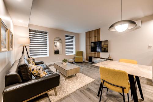 a living room with a couch and a table at 77 St-Vallier Apparts Hôtel in Quebec City