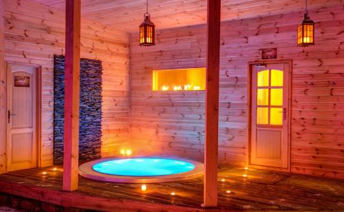 a hot tub in a room in a wooden house at Hotel Koliba Greta in Liptovská Sielnica