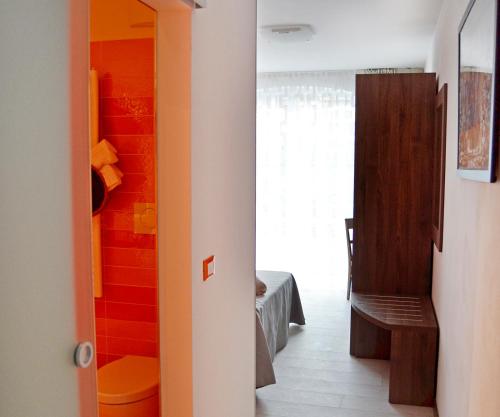 a hallway with a room with colorful walls at B&B Seventy Design in Dimaro