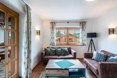 a living room with a couch and a table at Haus Kreiznegge in Inzell
