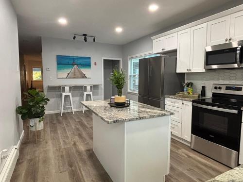 a kitchen with white cabinets and a counter top at Stylish 5 bedroom near Downtown Providence & Providence College in Providence