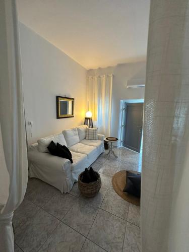 a living room with a white couch and a table at Panoramic view apartment in Megalokhori