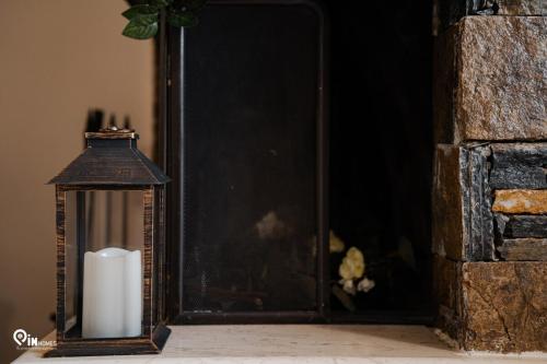a candle and a lantern sitting in front of a door at 'Four 4Season' With Amazing View in Vraná