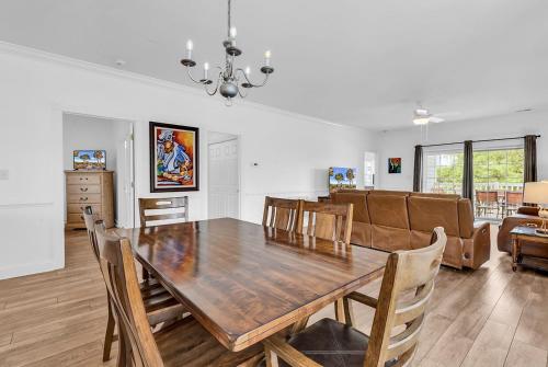 a dining room and living room with a table and chairs at Myrtlewood by Monarch Rentals in Myrtle Beach