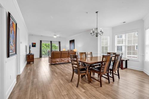 a dining room and living room with a table and chairs at Myrtlewood by Monarch Rentals in Myrtle Beach