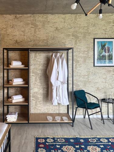 a room with a rack of clothes and a chair at Mountain View in Stepantsminda