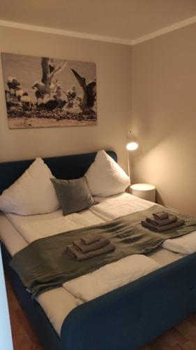 a bedroom with a bed with towels on it at Relax with a pool and sauna in Trave Kieker 005! in Rönnau