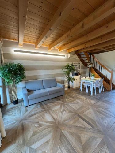 a living room with a blue couch and a table at Green Garda Holidays - Garda Lake in Castelnuovo del Garda