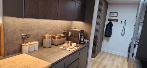 a kitchen with a counter top with a coffee maker at Coastal Rest in Beadnell
