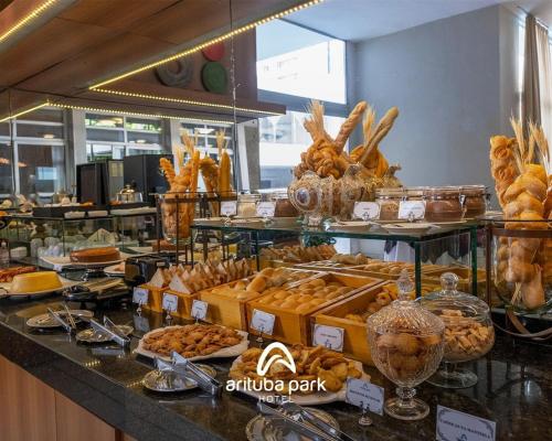 a buffet line with bread and pastries on display at Arituba Park Hotel in Natal