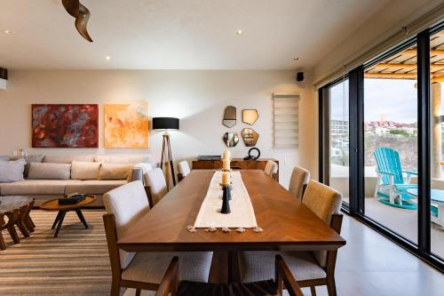 a living room with a wooden table and chairs at 3061 - Amanecer B2 in Tangolunda