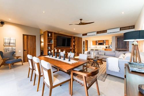a dining room and living room with a table and chairs at 3061 - Amanecer B2 in Tangolunda