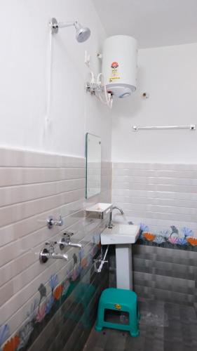 a bathroom with a sink and a mirror at CV Resort in Sonprayag