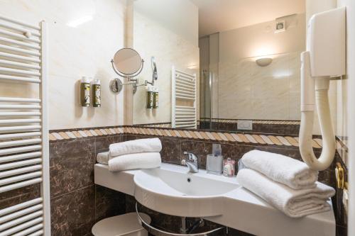a bathroom with a sink and a mirror at Monastero Resort & Spa - Garda Lake Collection in Soiano del Lago