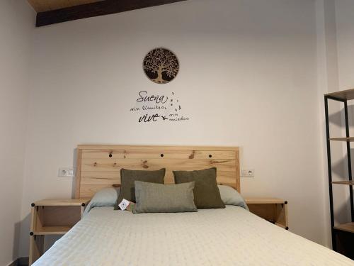 a bedroom with a bed with a white bedspread at CASA RURAL PUERTO-Otoño Mágico Valle del Ambroz in Casas del Monte