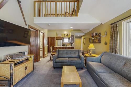 a living room with a couch and a table at The Woods - Village-11 in Killington