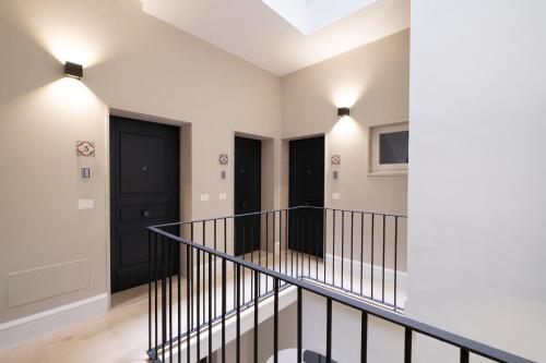 a staircase in a house with black doors at Palazzo Pisani - Bari in Bari