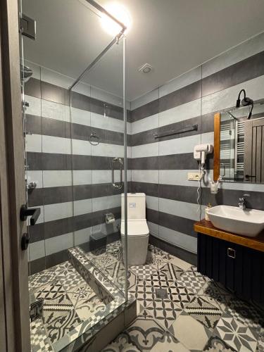 a bathroom with a glass shower and a sink at Mountain View in Stepantsminda