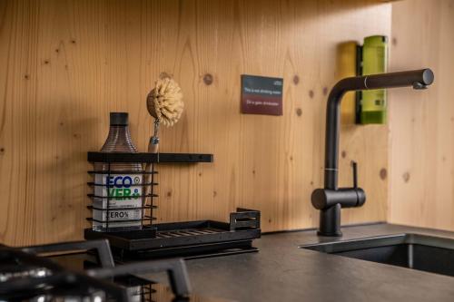 a kitchen counter with a sink and aaucet at Twente Cabin Tilligte in Tilligte