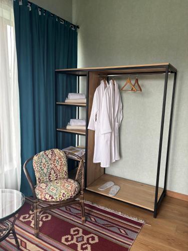a room with a mirror and a chair and a table at Mountain View in Stepantsminda