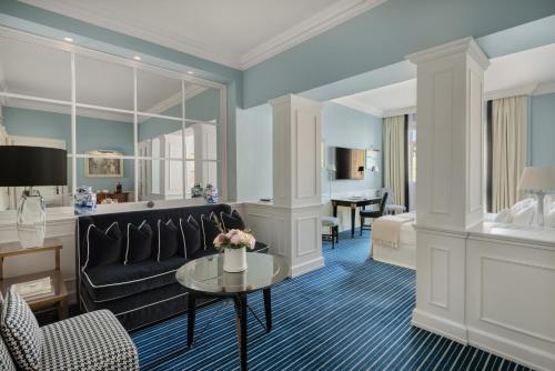 a living room with a couch and a table at Hotel Lungarno - Lungarno Collection in Florence