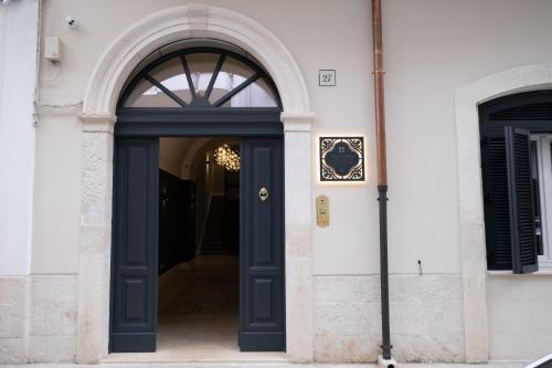 a blue door on a white building at Palazzo Pisani - Bari in Bari
