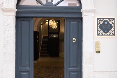 a blue door of a building with a staircase at Palazzo Pisani - Bari in Bari