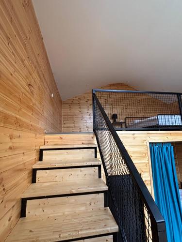 a staircase in a room with wooden walls and ceilings at Mountain View in Stepantsminda