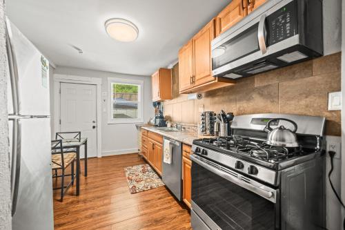 a kitchen with a stove and a refrigerator at Cedar Blossom Bungalow is a cozy getaway with a 5 minute walk to downtown! in Hot Springs