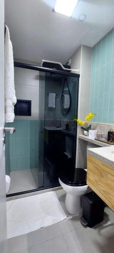 a bathroom with a shower with a toilet and a sink at ArtStudio Open Spaces in Salvador