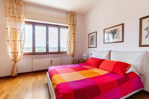 a bedroom with a colorful bed and a large window at Modern Apartment in La Spezia with Stunning Views - 75 m² in La Spezia