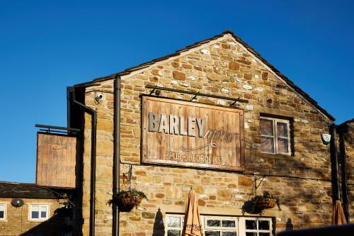 a building with a bakery sign on the side of it at Barley Mow in Burnley