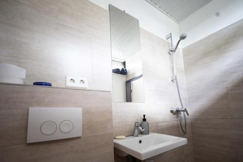 a bathroom with a white sink and a mirror at Kapelle Elbtalaue - Kirchensaal in Hitzacker