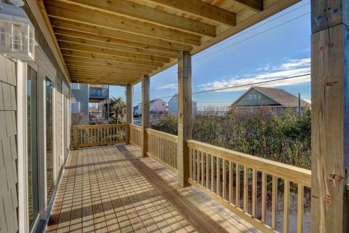 a wooden porch with a view of the ocean at 2701- A S Shore Drive - Threefoot in Surf City